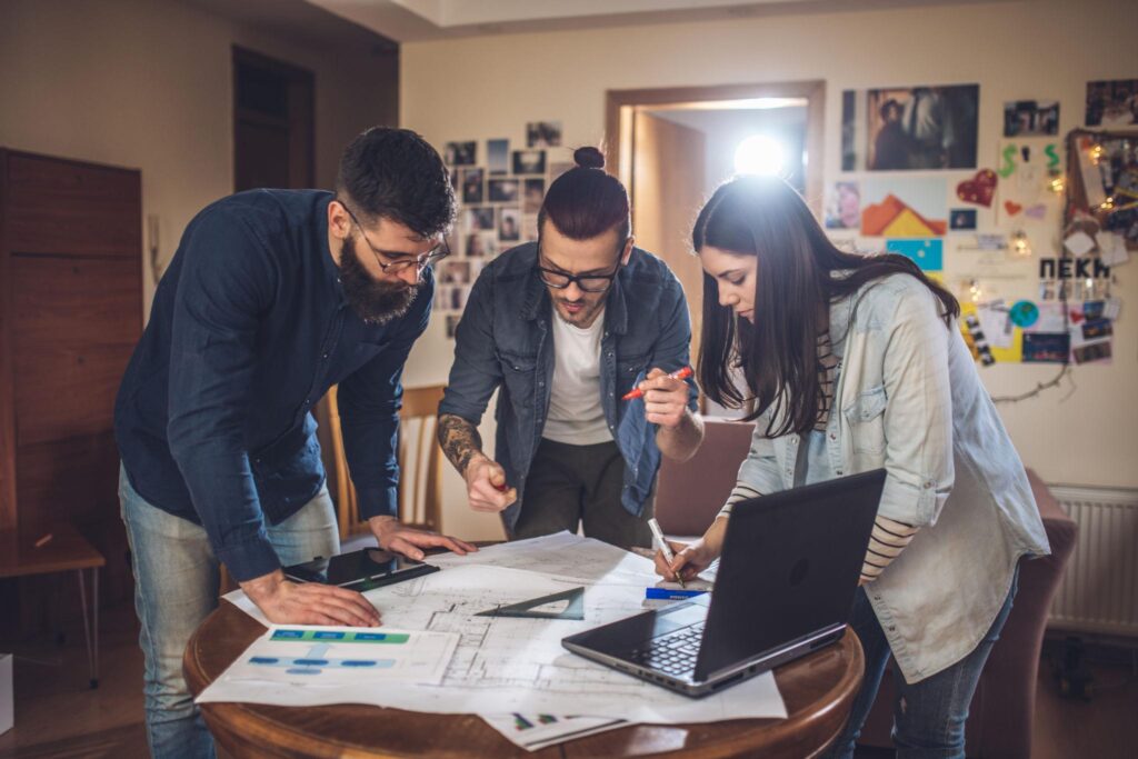 Startup founders working from a small apartment representing Airbnb's early entrepreneurial journey