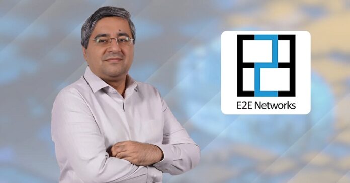 E2E Networks executive alongside the company logo, representing the AI cloud infrastructure provider's strong Q1 FY27 financial performance and rapid growth in GPU-powered cloud services.