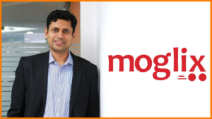 Rahul Garg, founder and CEO of Moglix, standing beside the Moglix logo at the company's office in India.