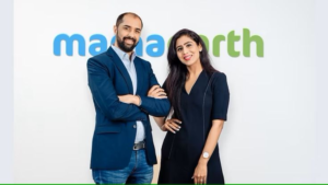 Varun Alagh and Ghazal Alagh, co-founders of Honasa Consumer and Mamaearth, standing in front of the Mamaearth logo representing India's leading digital-first beauty and personal care brand.