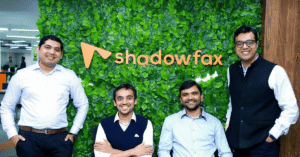 Shadowfax founders and leadership team standing in front of the Shadowfax logo at the company office.