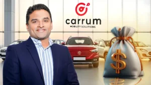 Carrum Mobility Solutions founder standing in front of a car dealership with the company logo and automotive vehicles.