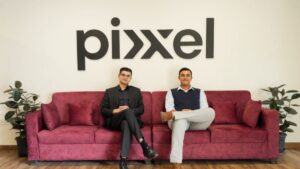 Pixxel founders seated in the company office beneath the Pixxel logo.